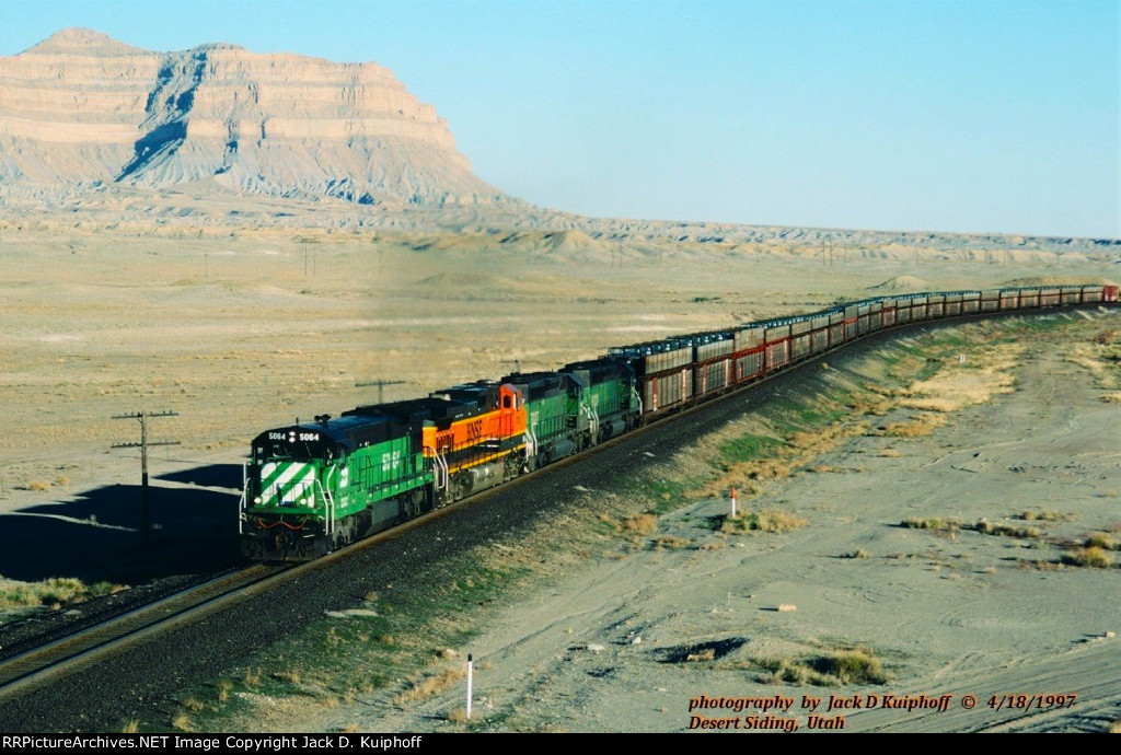 Burlington Northern, BN C30-7 5064 -BNSF C44-9w 1112 -SD40-2 7027 -8131 with a westbound on the ex-D&RGW at Desert Siding, Utah. April 18, 1997. 